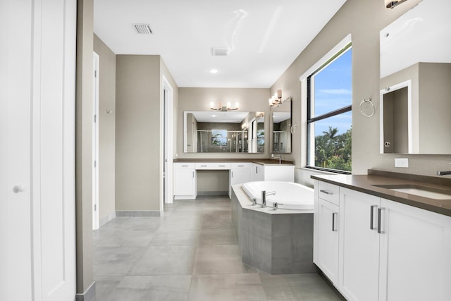 bathroom featuring vanity and a relaxing tiled tub