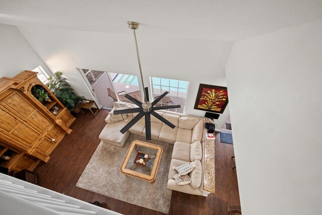 bedroom featuring a textured ceiling, dark wood-type flooring, and ceiling fan