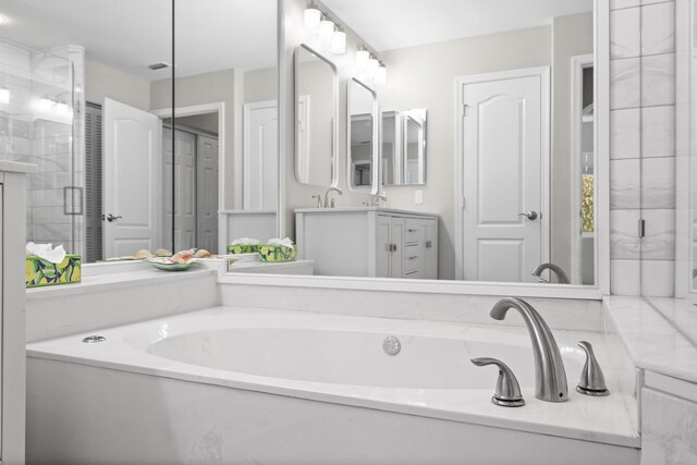 clothes washing area featuring washer and dryer, cabinets, and dark hardwood / wood-style floors