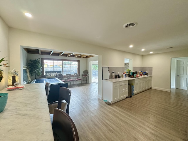 kitchen featuring light hardwood / wood-style floors and backsplash