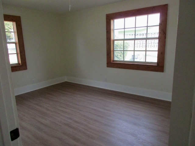 unfurnished room featuring dark hardwood / wood-style floors