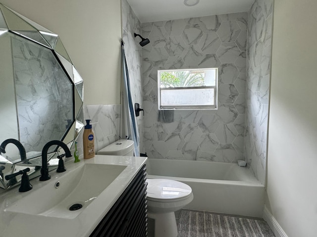 full bathroom with vanity, hardwood / wood-style flooring, tiled shower / bath combo, and toilet