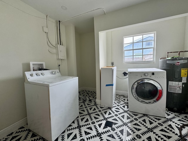 washroom with water heater and washer and clothes dryer