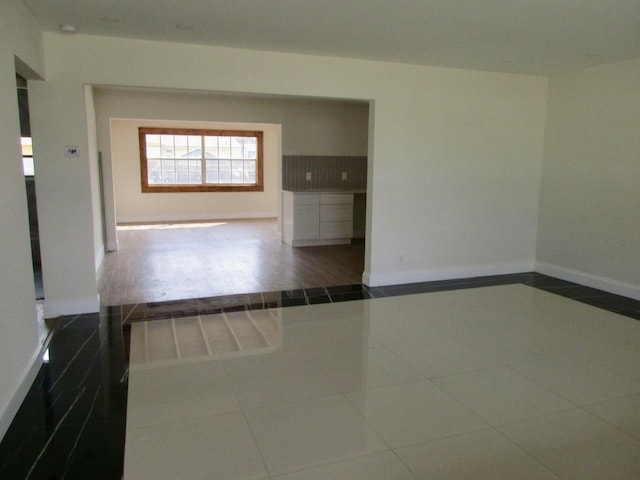 empty room featuring dark tile patterned flooring