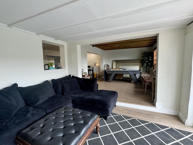 living room featuring hardwood / wood-style flooring and beamed ceiling