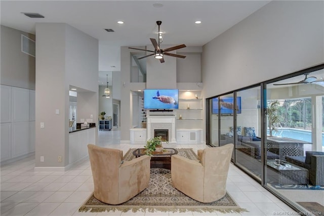 tiled living room featuring a towering ceiling and ceiling fan