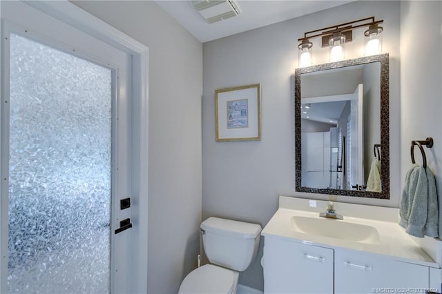 bathroom with toilet and vanity