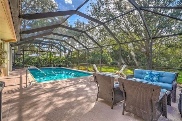 view of pool with outdoor lounge area, glass enclosure, and a patio