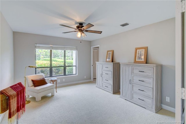 living area with ceiling fan and light colored carpet