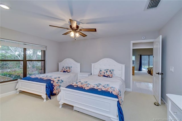 bedroom featuring light colored carpet and ceiling fan