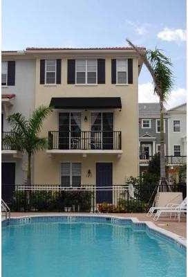 rear view of house with a balcony and a community pool