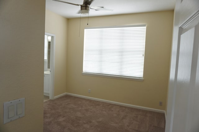 unfurnished room featuring ceiling fan and carpet flooring