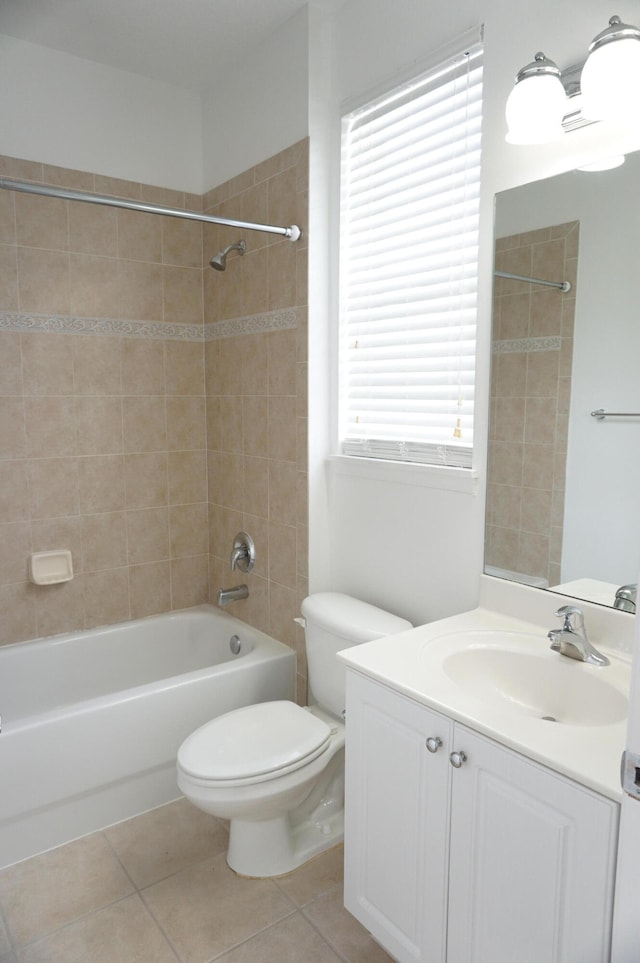 full bathroom featuring toilet, tiled shower / bath combo, vanity, and tile patterned floors