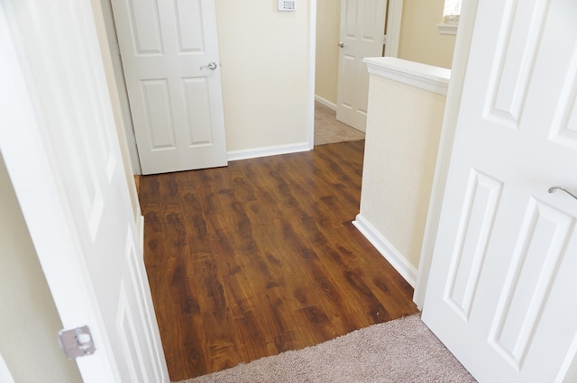 corridor with dark hardwood / wood-style floors