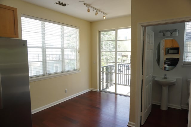 doorway with sink and dark hardwood / wood-style flooring