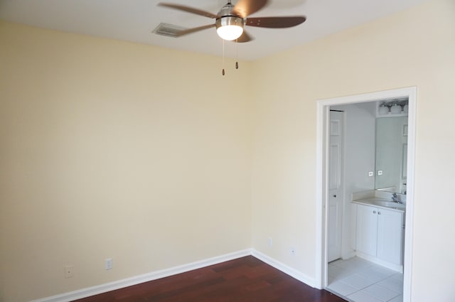 empty room featuring ceiling fan and hardwood / wood-style floors