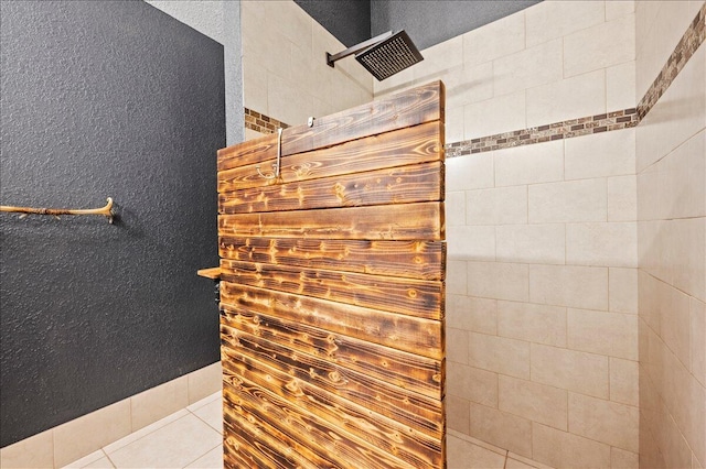 bathroom featuring a tile shower and tile patterned floors