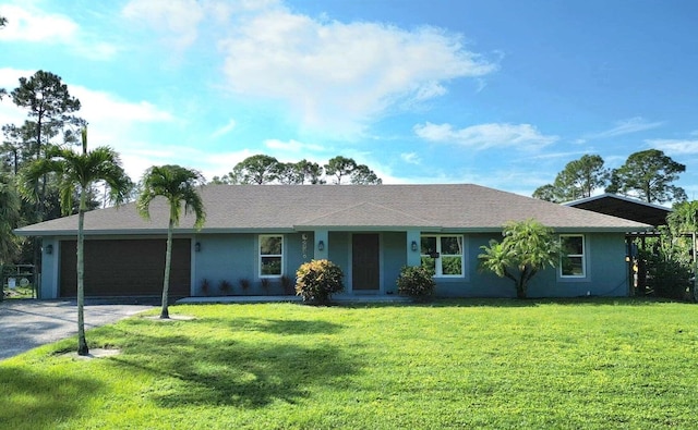 ranch-style house featuring a garage and a front lawn