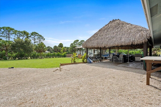 view of community featuring a gazebo, a yard, and a patio