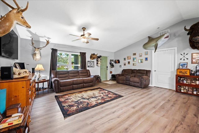 living room featuring lofted ceiling, light hardwood / wood-style flooring, and ceiling fan