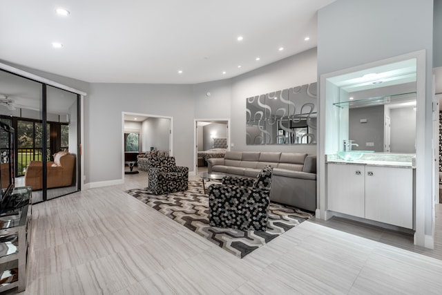 living room with ceiling fan and lofted ceiling