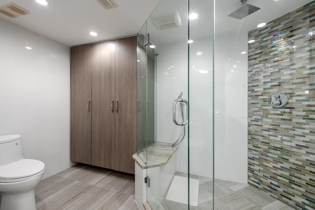 bathroom featuring toilet and walk in shower