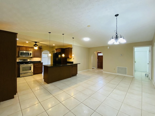 kitchen featuring ceiling fan with notable chandelier, light tile patterned flooring, decorative light fixtures, and appliances with stainless steel finishes