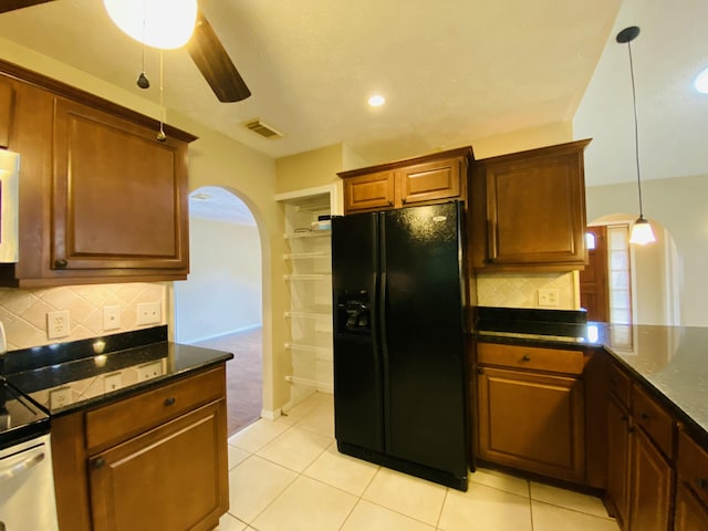 kitchen featuring tasteful backsplash, black fridge with ice dispenser, ceiling fan, range, and light tile patterned flooring