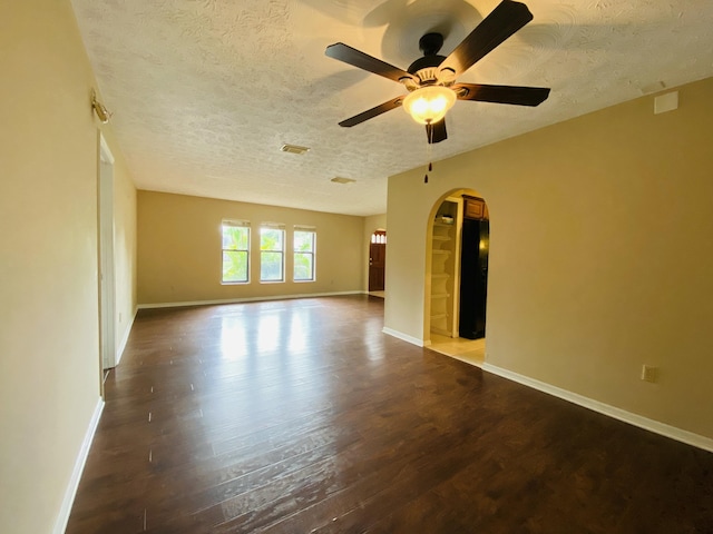 spare room with ceiling fan, wood-type flooring, and a textured ceiling