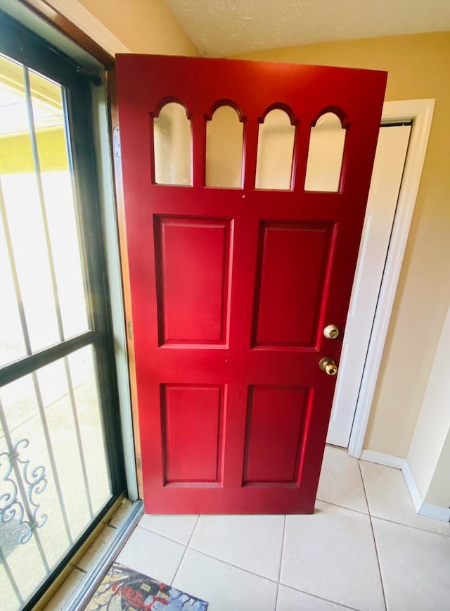 foyer entrance with light tile patterned flooring