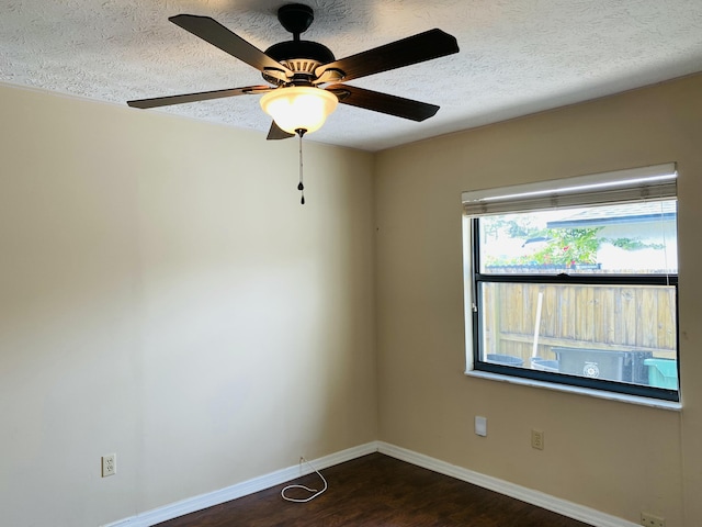 spare room with ceiling fan, dark hardwood / wood-style floors, and a textured ceiling