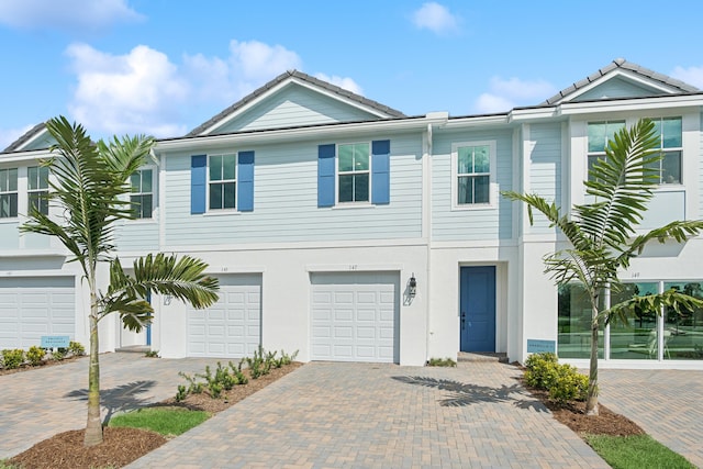 townhome / multi-family property featuring a garage