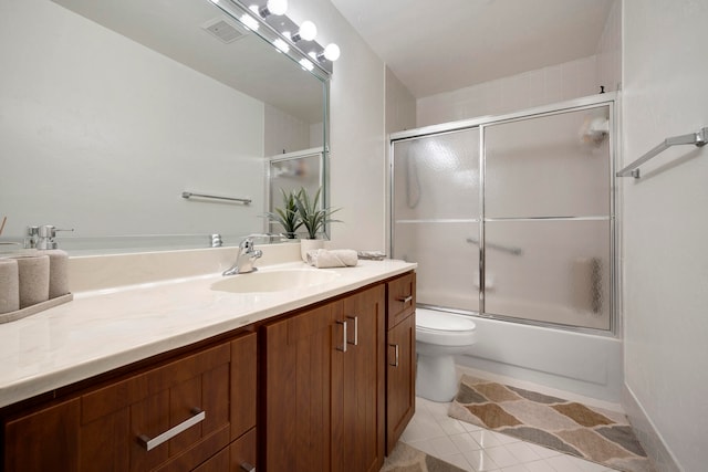 full bathroom with vanity, toilet, tile patterned floors, and shower / bath combination with glass door