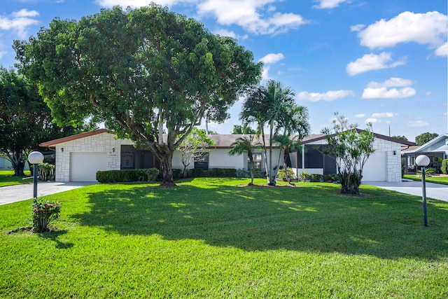 single story home featuring a front lawn and a garage