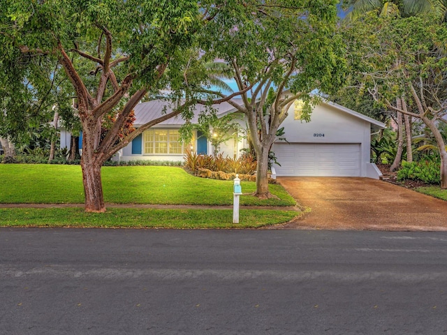 ranch-style home with a front yard and a garage