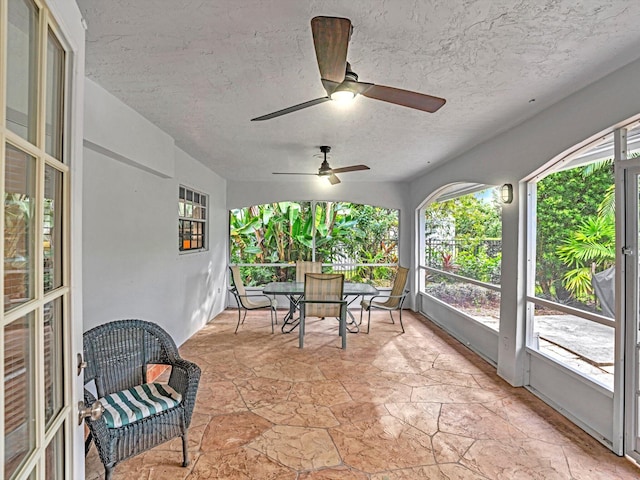 sunroom / solarium featuring ceiling fan