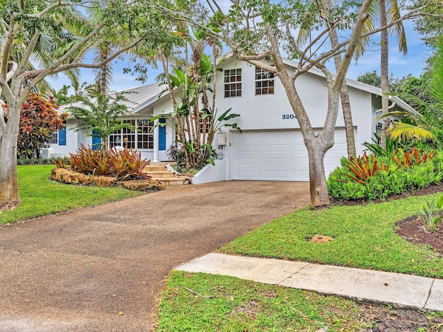 view of front facade with a garage and a front lawn