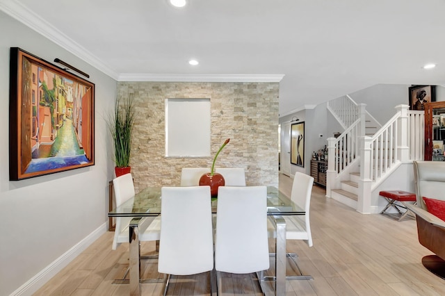 dining area with crown molding and light wood-type flooring