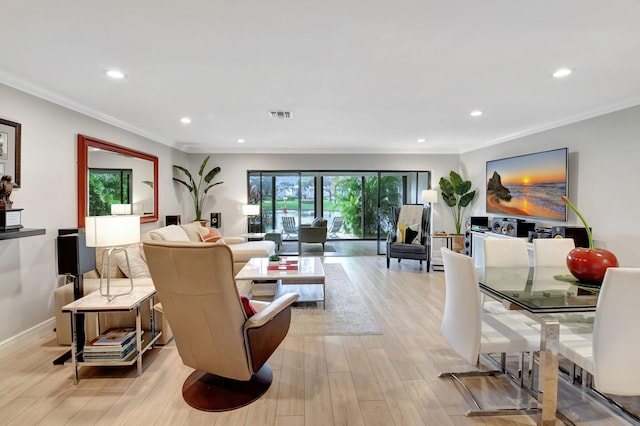 living room featuring ornamental molding and light hardwood / wood-style flooring