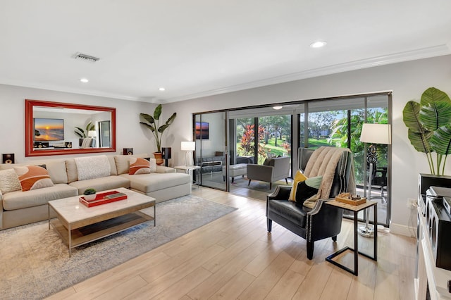 living room with light hardwood / wood-style flooring and crown molding