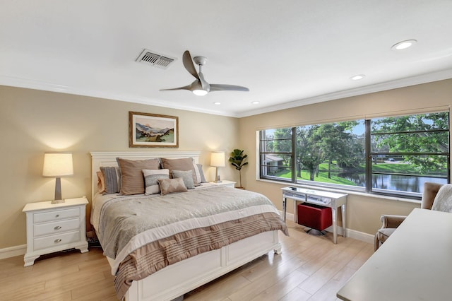 bedroom with crown molding, light hardwood / wood-style floors, and ceiling fan