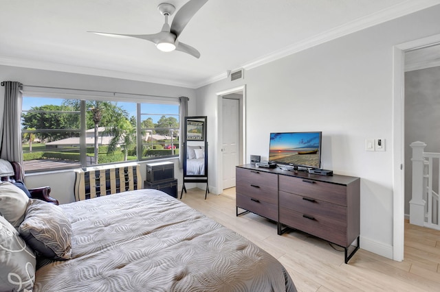 bedroom with ornamental molding, light wood-type flooring, and ceiling fan