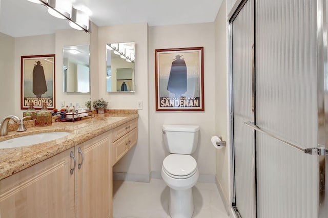 bathroom with vanity, a shower with shower door, and toilet