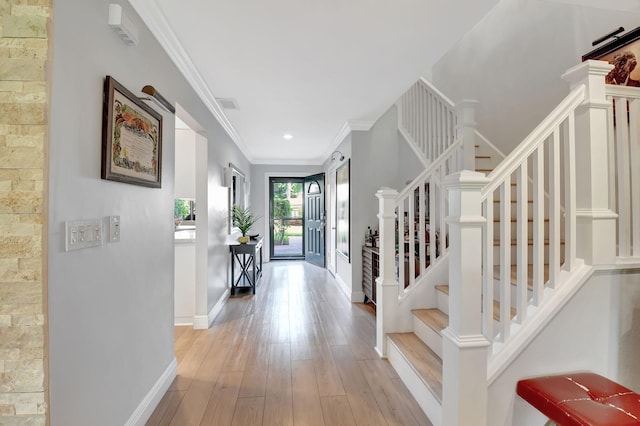 entrance foyer featuring light hardwood / wood-style flooring and crown molding