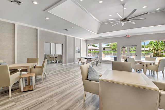 dining area with french doors, light wood-type flooring, and ceiling fan