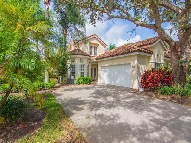 mediterranean / spanish-style home with a garage