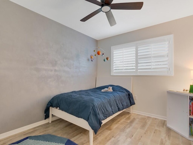 bedroom featuring light hardwood / wood-style floors and ceiling fan