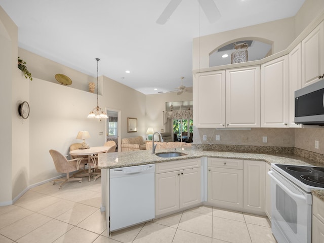 kitchen with kitchen peninsula, hanging light fixtures, white cabinetry, sink, and white appliances