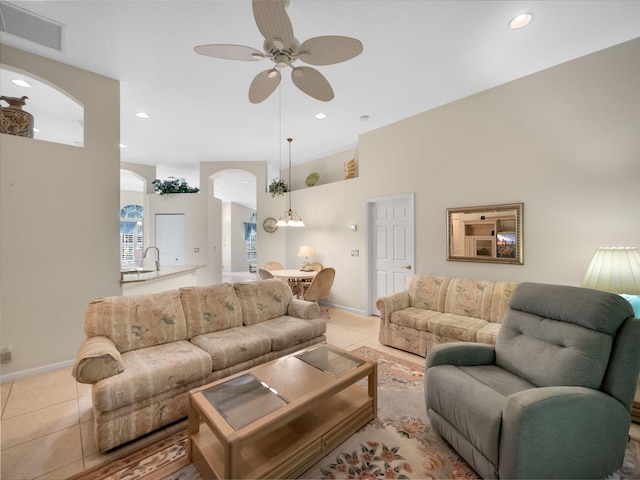 living room featuring light tile patterned flooring and ceiling fan