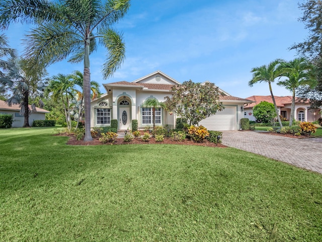 mediterranean / spanish-style house with a front yard and a garage